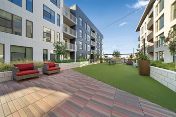 Terrace lounge featuring barbecue pavilion, lawn games and outdoor fireplace